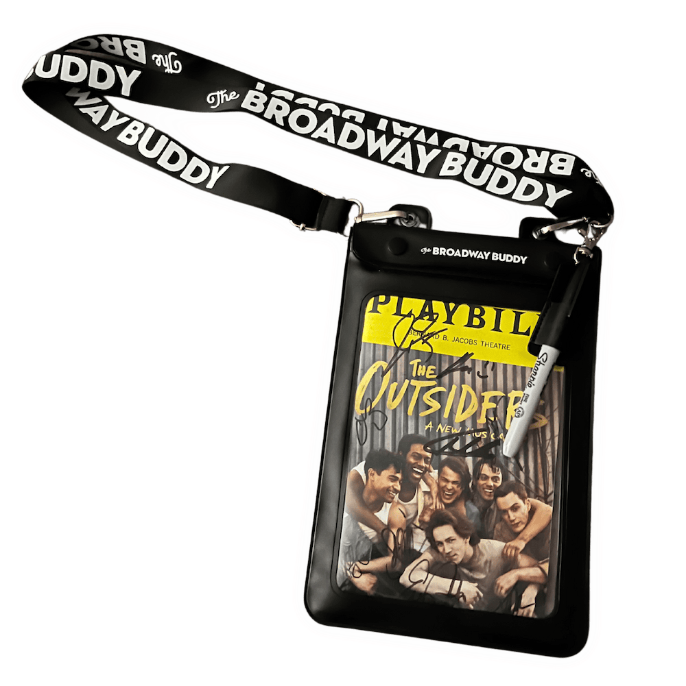 A signed Playbill for "The Outsiders" in a clear holder with a stylus pen attached. The holder is branded "The Broadway Buddy" with a matching lanyard.