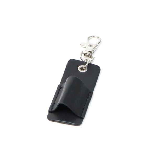 The Stagedoor Marker Holder: A black leather keychain featuring a metal clasp and loop attachment, beautifully showcased on a white background.